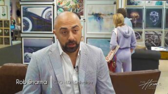 Image: man with dark beard and pinstripe suit jacket in front of wall of framed art prints. Text: Rob Sharma, CEO, LDN Collections