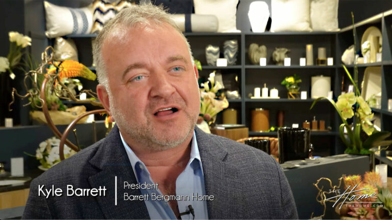image: man with short beard in dark gray jacket in Barrett Bergmann Home showroom. Text: Kyle Barrett, President, Barrett Bergmann Home