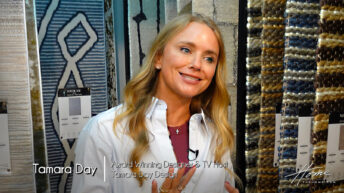 Image: blonde smiling woman Tamara Day in button down white shirt standing in rug showroom