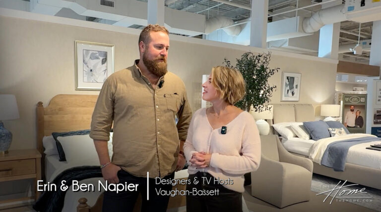 tall man in tan button down shirt standing next to shorter woman in white sweater in Vaughan-Bassett bedroom collection showroom