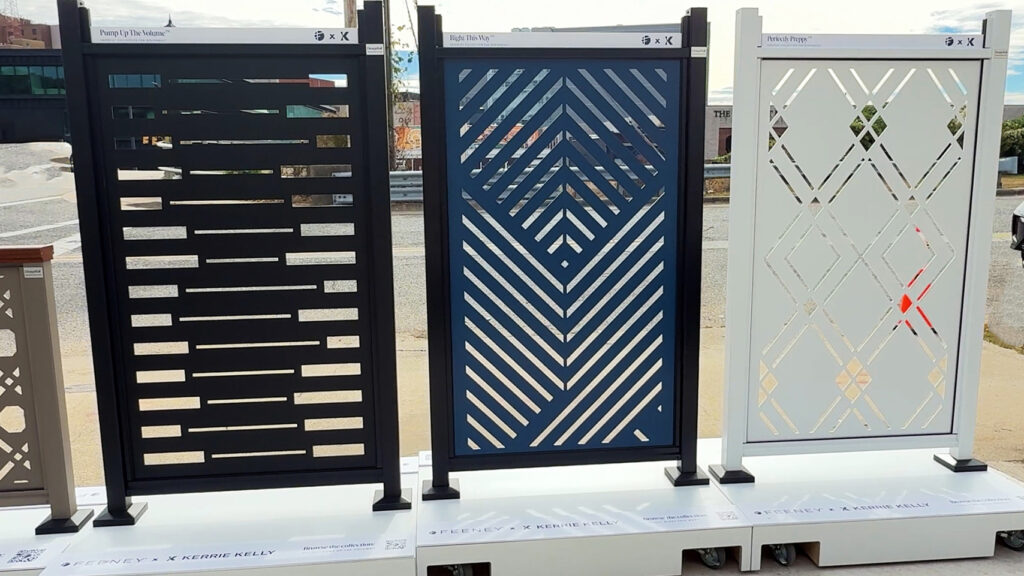 3 standing samples of Feeney X Kerrie Kelly laser-cut railing designs: black, blue, and creamy white, patterns vary