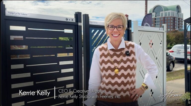 woman with blond short hair in burgundy and pink vest outside in front of laser-cut architectural railings