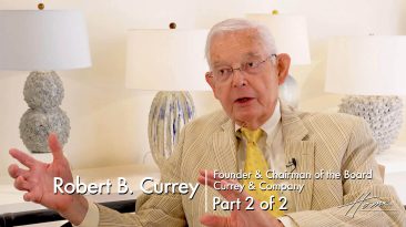 Currey & Company showroom with older man with white hair expressing with hands, wearing yellow and tan seersucker suit jacket, art lamps in background. Text: Robert B. Currey Founder & Chairman of the Board, Currey & Company, Part 2 of 2
