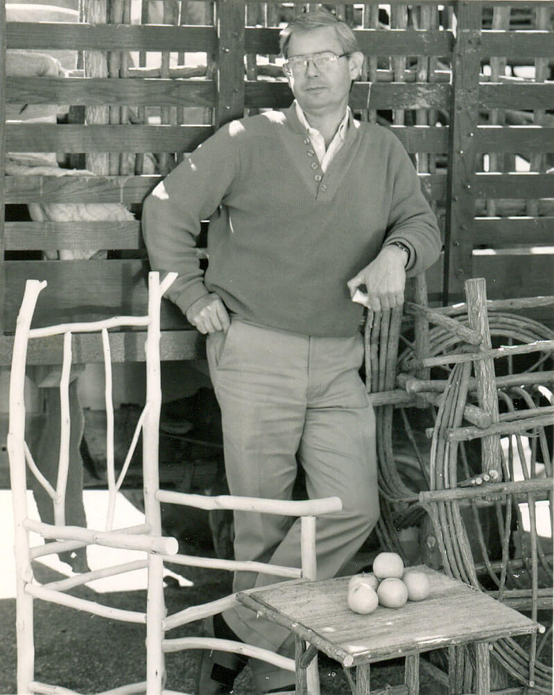 black and white photo of Robert Currey in early years with antique garden furniture